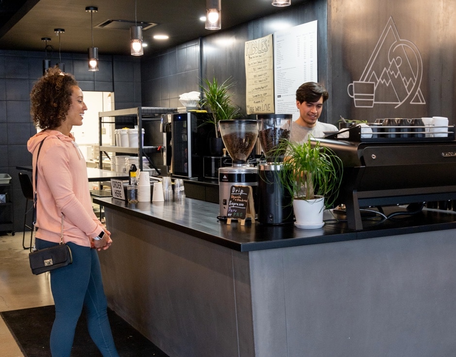 Barista making hot espresso latte for customer in Salt Lake City coffee shop | Cupla Coffee